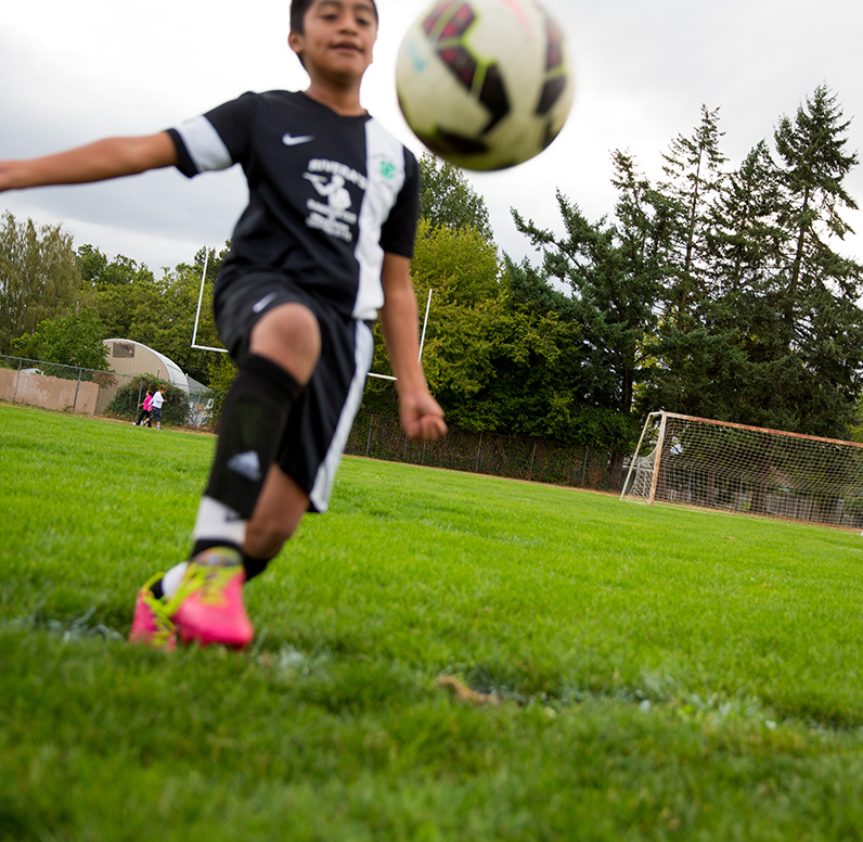 boy about to kick a soccer ball