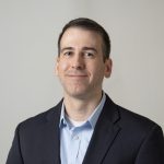 a headshot of Christopher Blesso